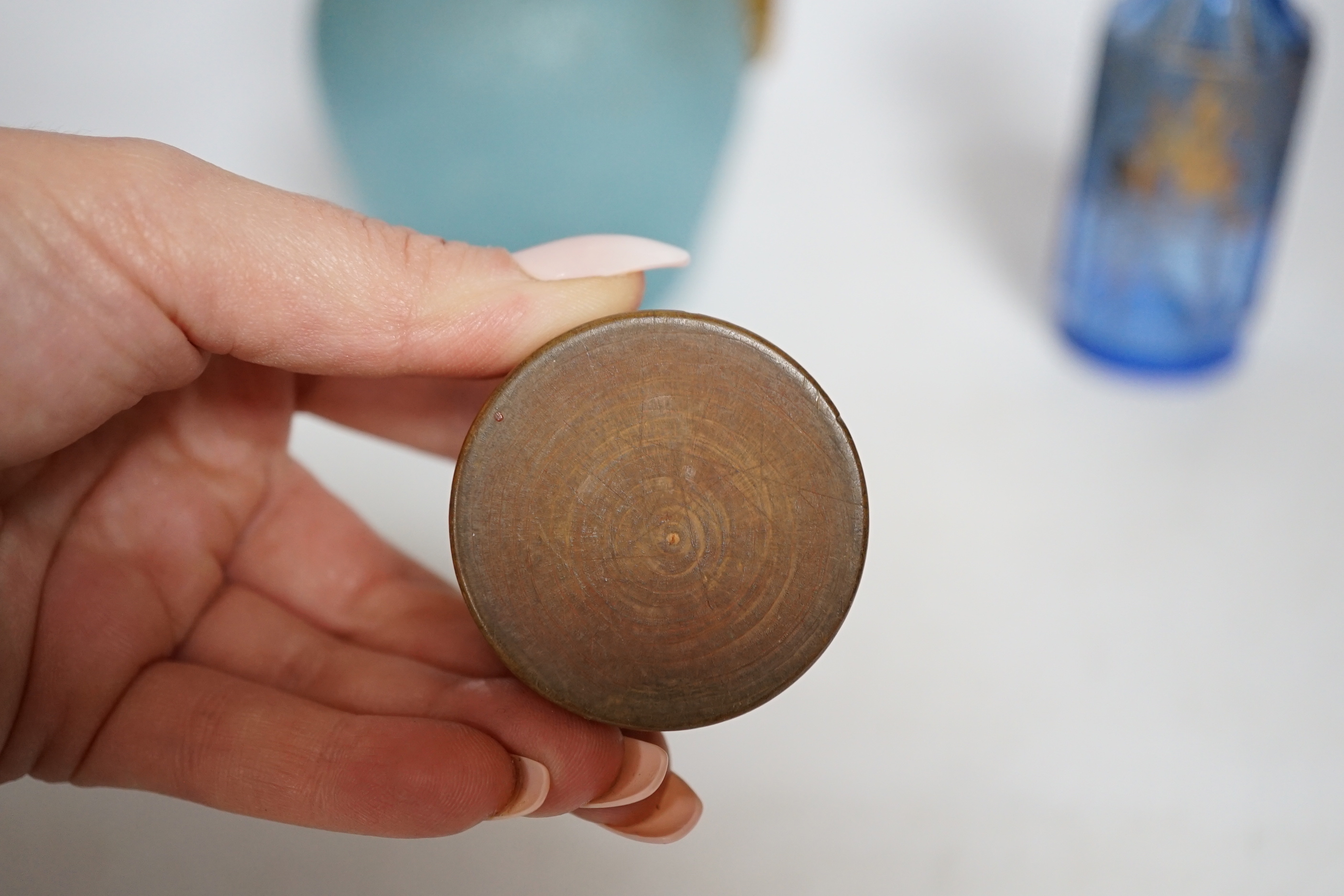 A 19th century Japanese Hirado blue and white cylindrical box and cover, height 8cms, a gold classically decorated glass bottle and a frosted glass jug and wooden pot (4)